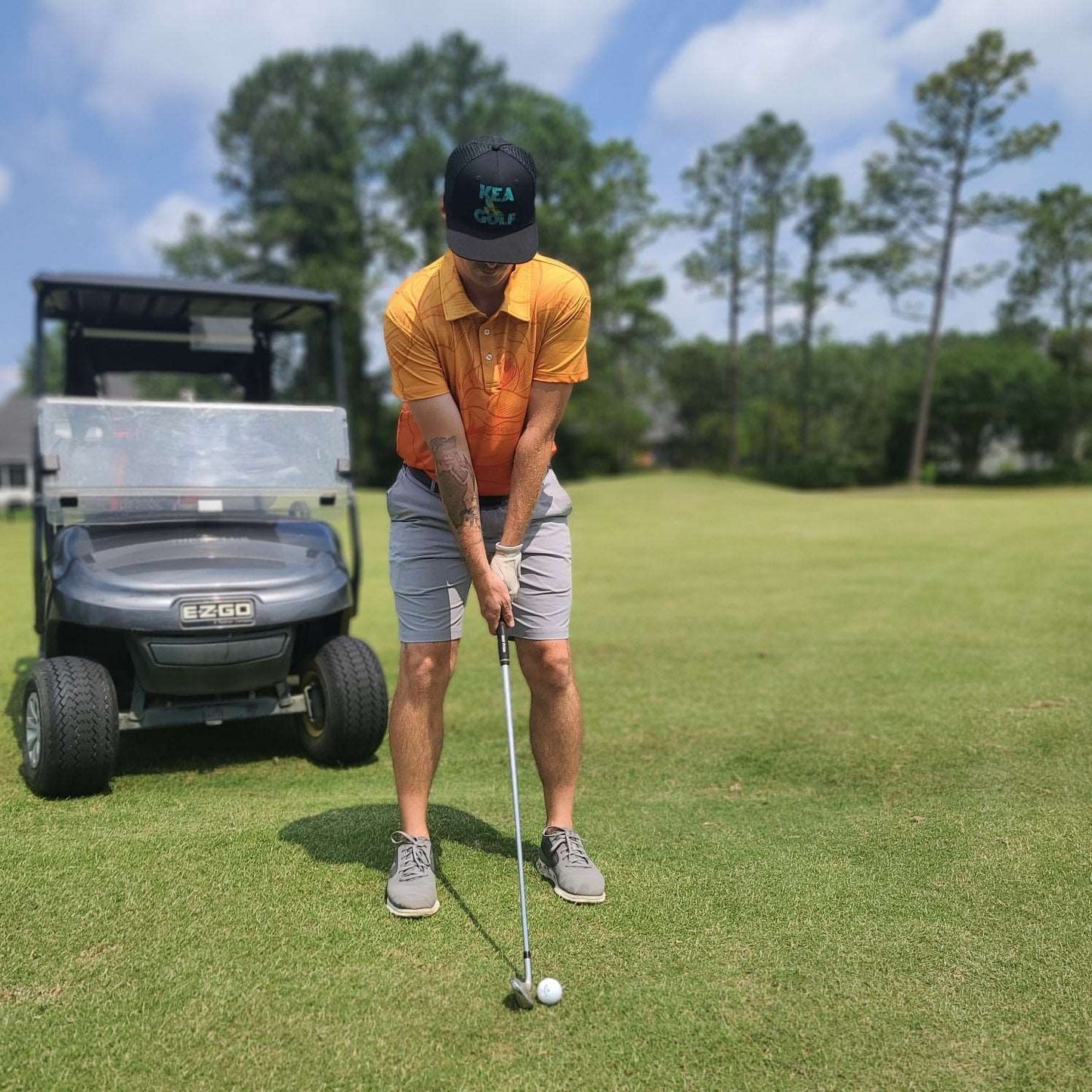 color fade orange golf shirt with floral pattern. men's golf shirts